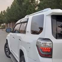 May be an image of car, road and text